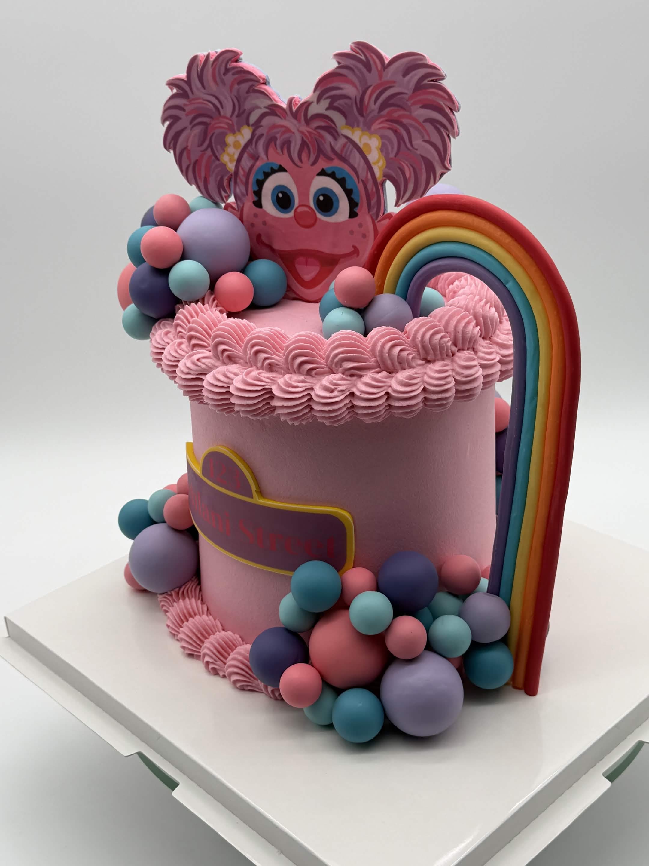 A decorated layer cake with frosting and cake slices.